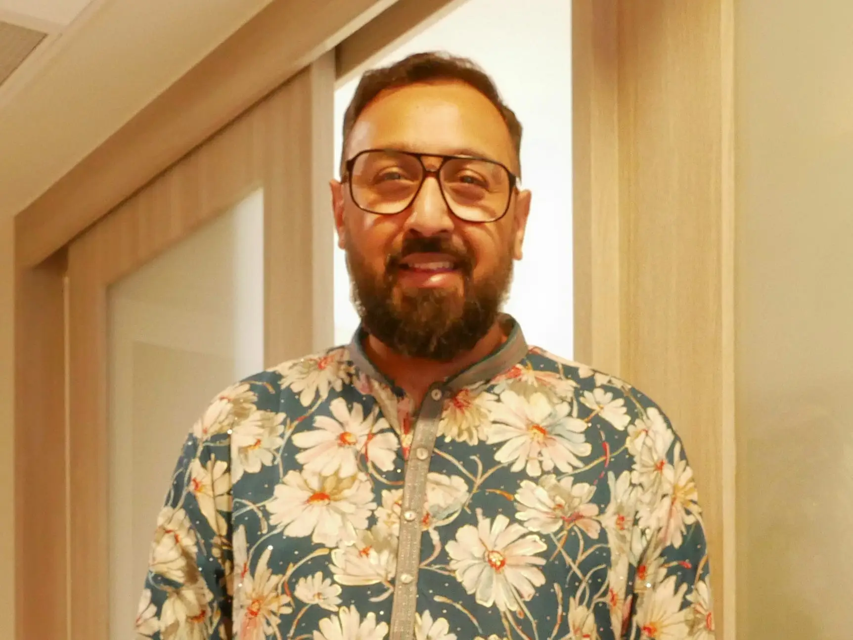 Mohammad Samad poses for a photo in a hotel room.