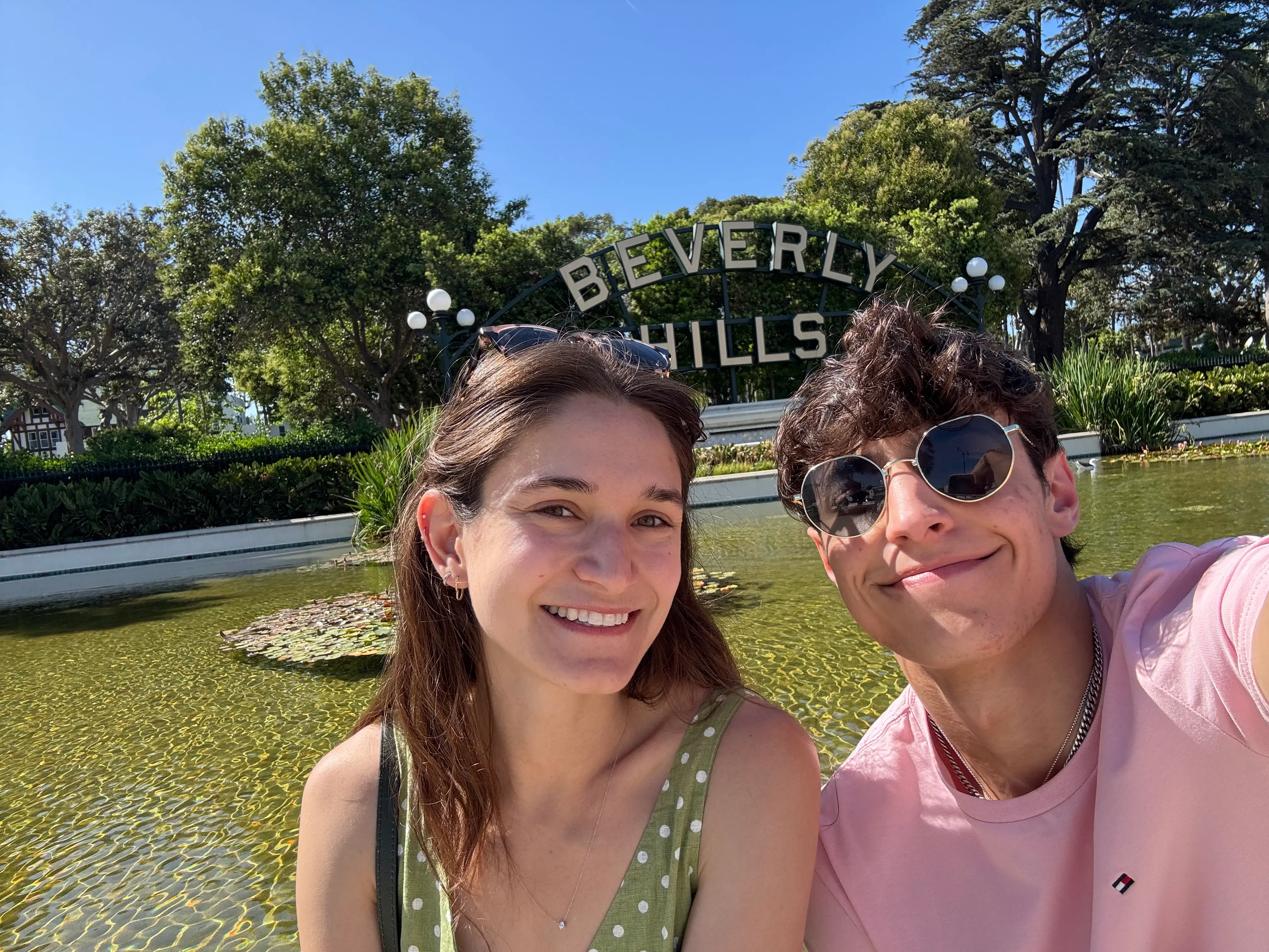 Anna and her brother pose in front of the Beverly Hills sign.