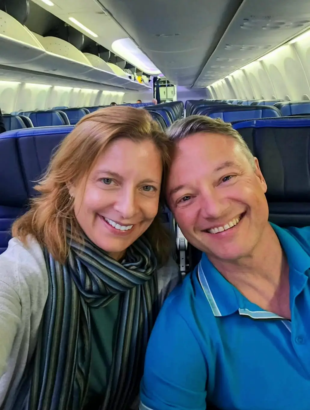 Kelly Magyarics and her partner sitting on a plane