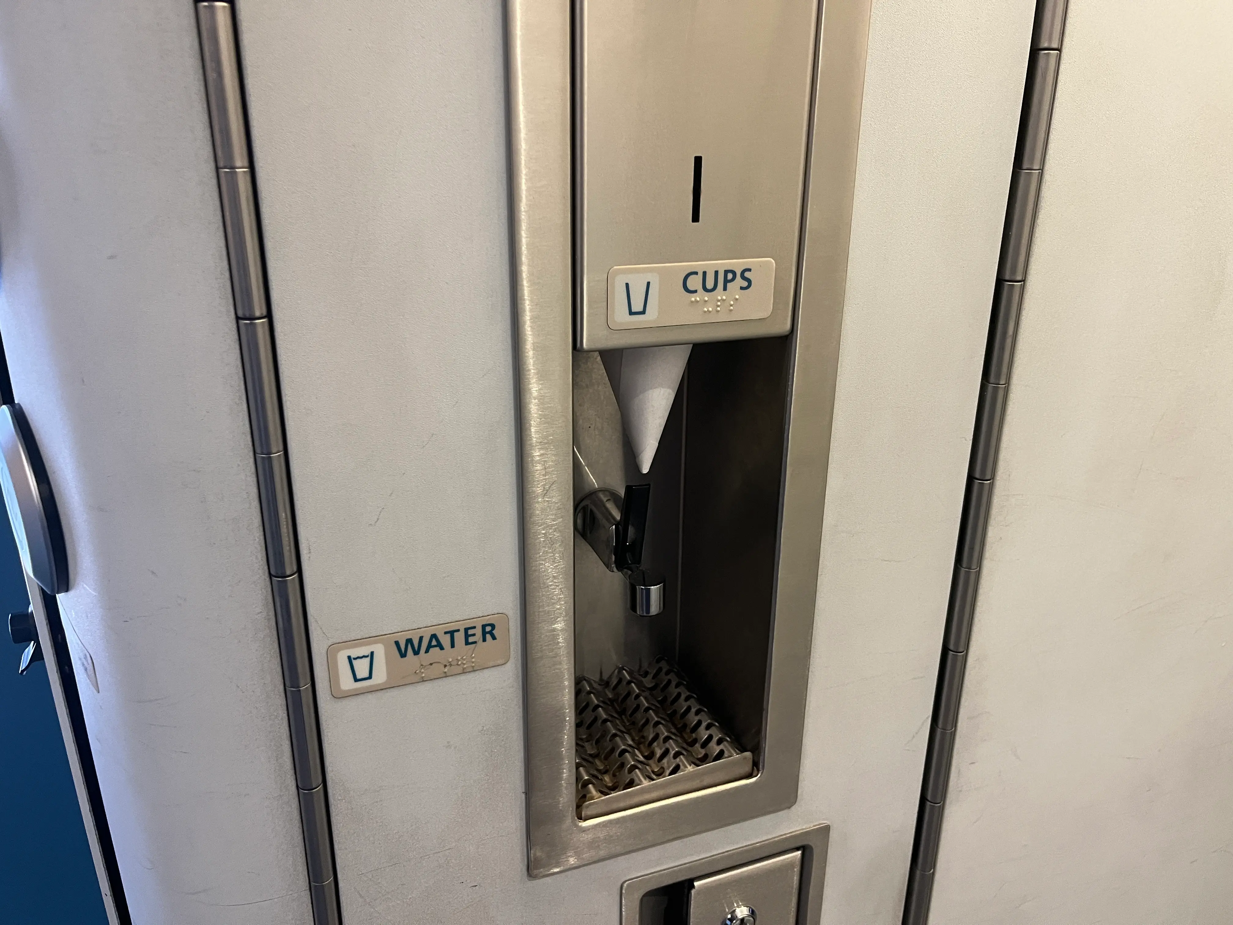 Drinking water and cups in business class.