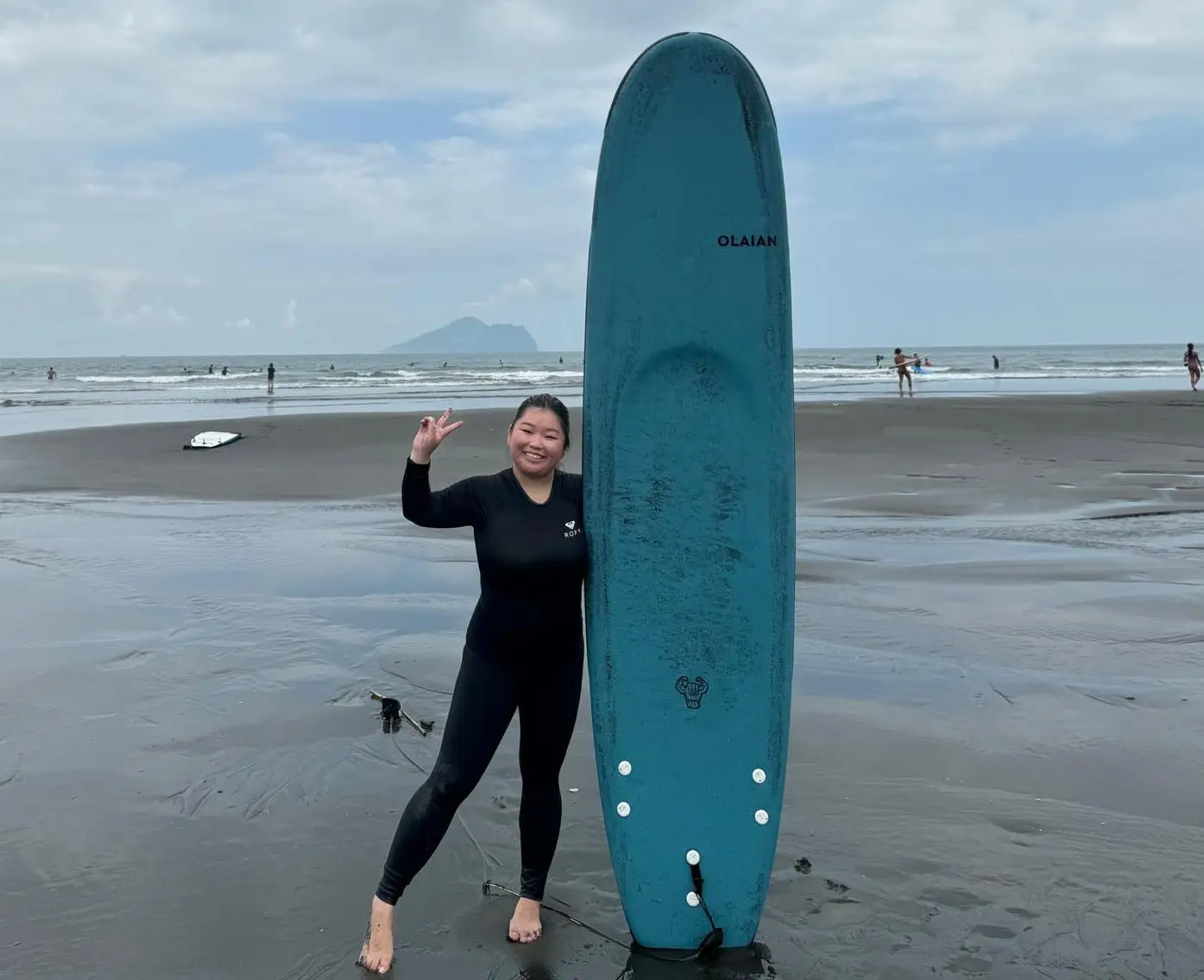 Chloe Lee holding a surfboard