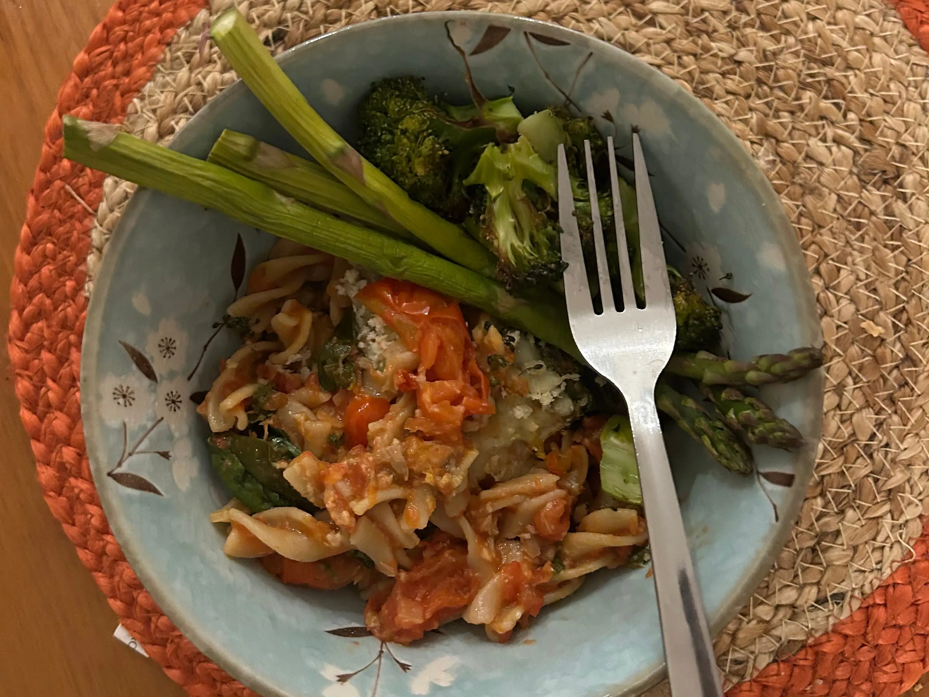 A bowl of tuna pasta bake with green vegetables.