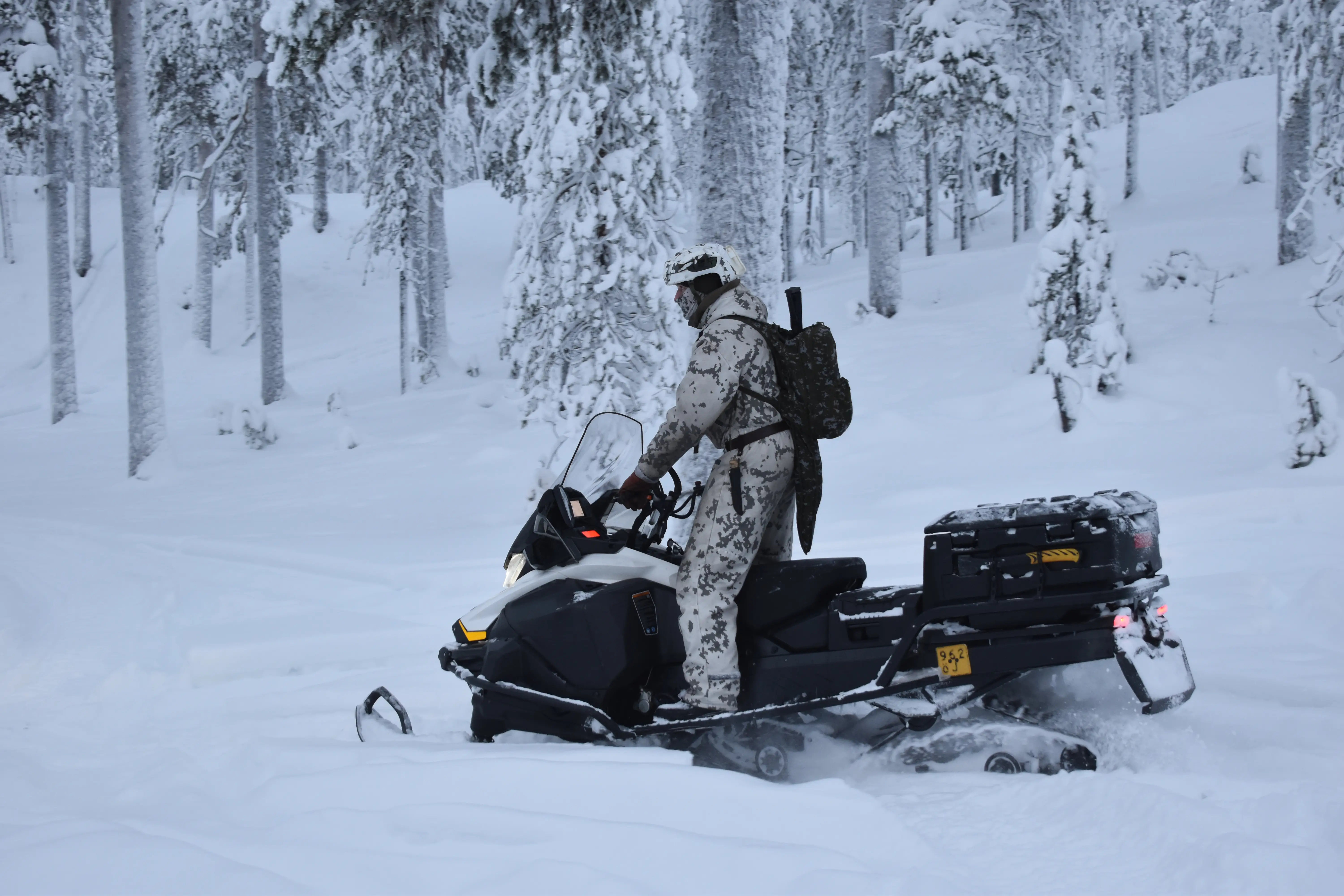 A NATO soldier rides a snowmobile in northern Finland in January 2026.