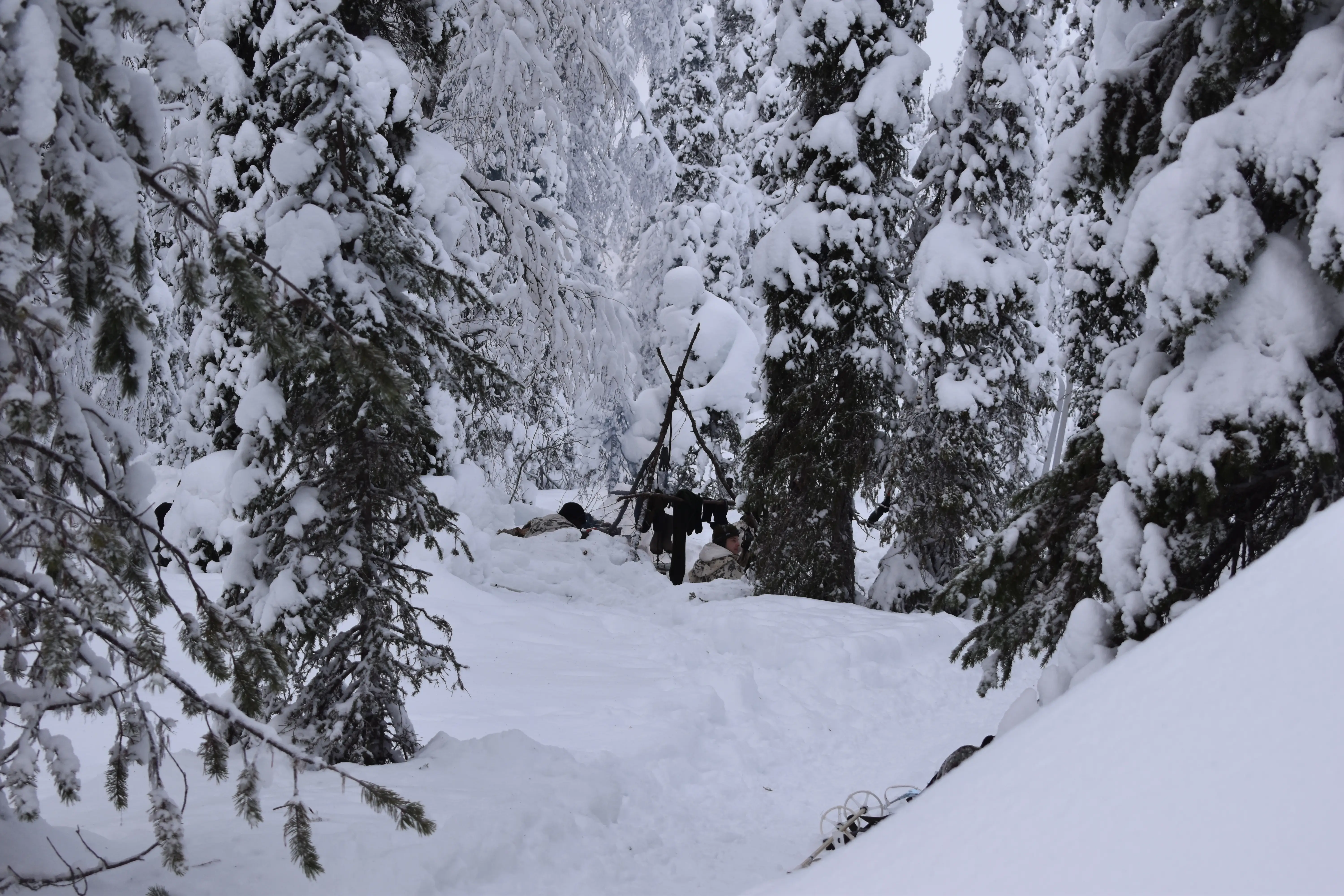 NATO soldiers sit next to a fire in northern Finland in January 2026.