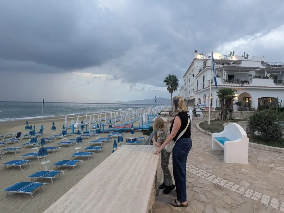 Tegan Forder and her daughter on a beach in Italy