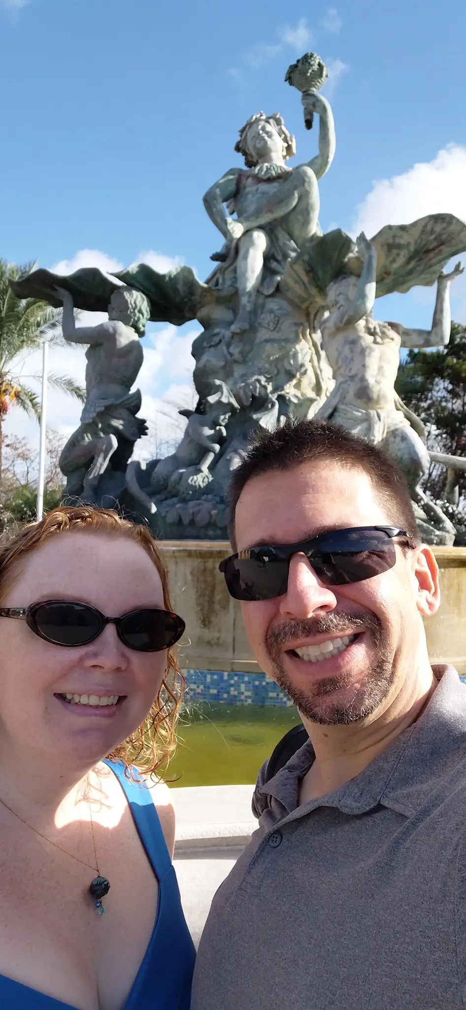 A selfie of a man and woman in front of a fountain in Malta.