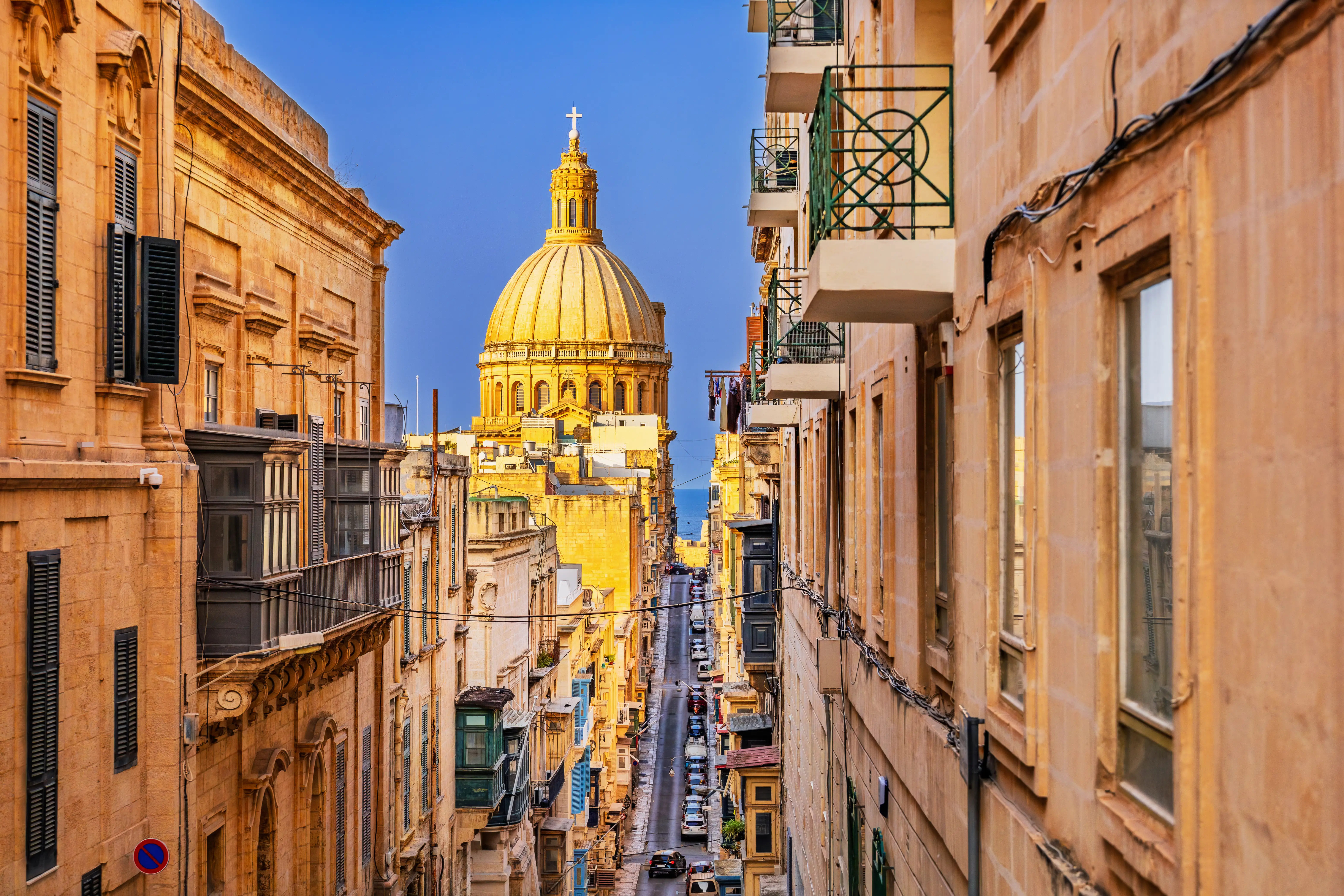 Valletta, Malta. Street that leads down to the Grand Harbour and St Paul's Cathedral's dome.