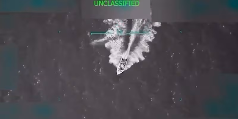 Black and white image of boat riding on the ocean.