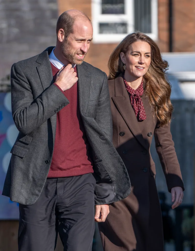 Prince William and Catherine, Princess of Wales, walking outdoors.