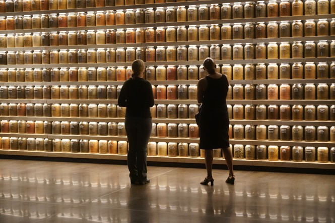 Visitors stand before an exhibit at The Legacy Museum