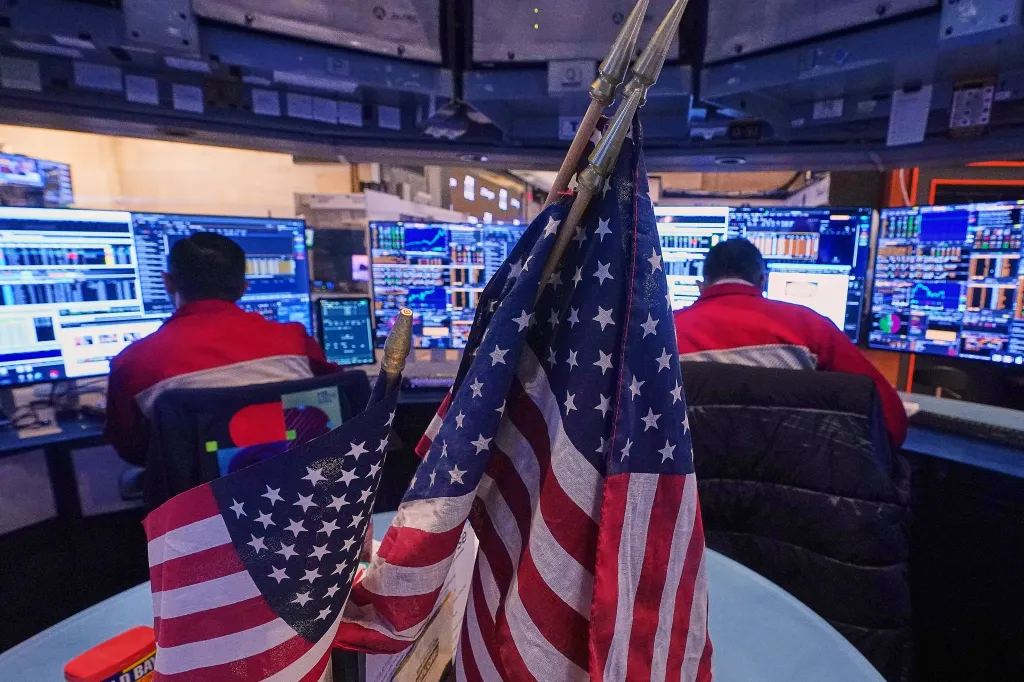 A pair of traders work on the floor of the New York Stock Exchange, Monday, Jan. 12, 2026.