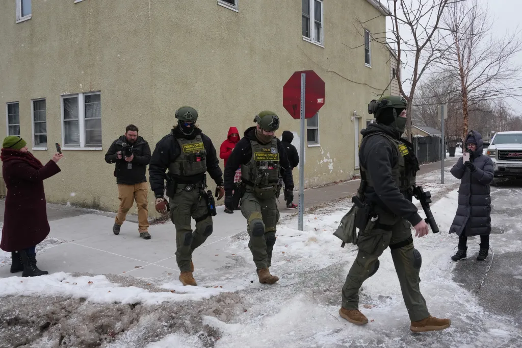 Federal officers from the Bureau of Prisons outside a residence in Minnesota.