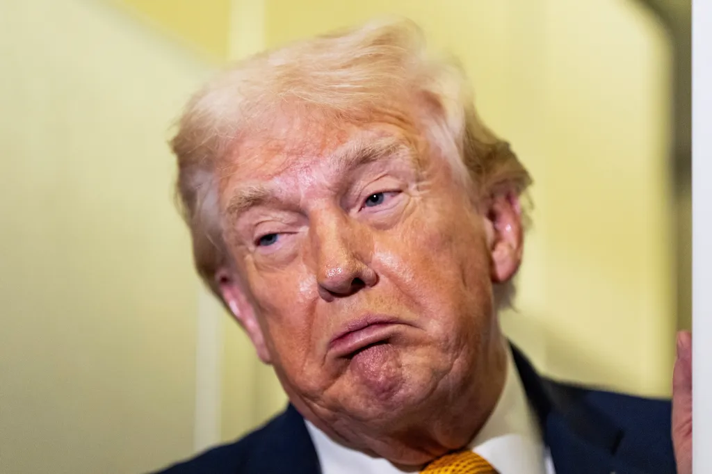 President Donald Trump reacts as he was speaking with reporters while in flight on Air Force One, Sunday, Jan. 4, 2026