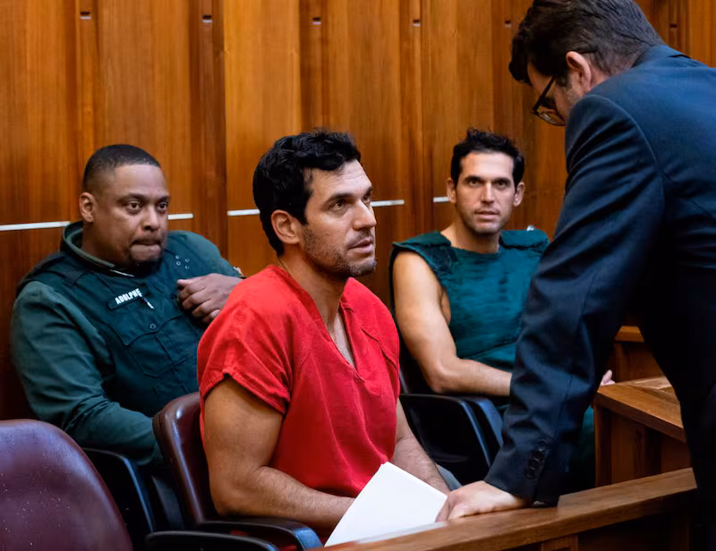 Oren Alexander, 37, center, and his twin brother, Alon, center-right, speak to their attorney Joel Denaro during their bond hearing at the Richard E. Gerstein Justice Building on Thursday, Dec. 12, 2024, in Miami, Fla. Oren, alongside his twin brother Alon Alexander, have been charged with multiple state and federal crimes, including sex trafficking and rape.