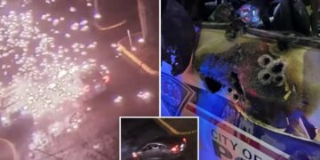 Video shows police officer ambushed in patrol car in explosion of gunfire; suspect found dead after shootout