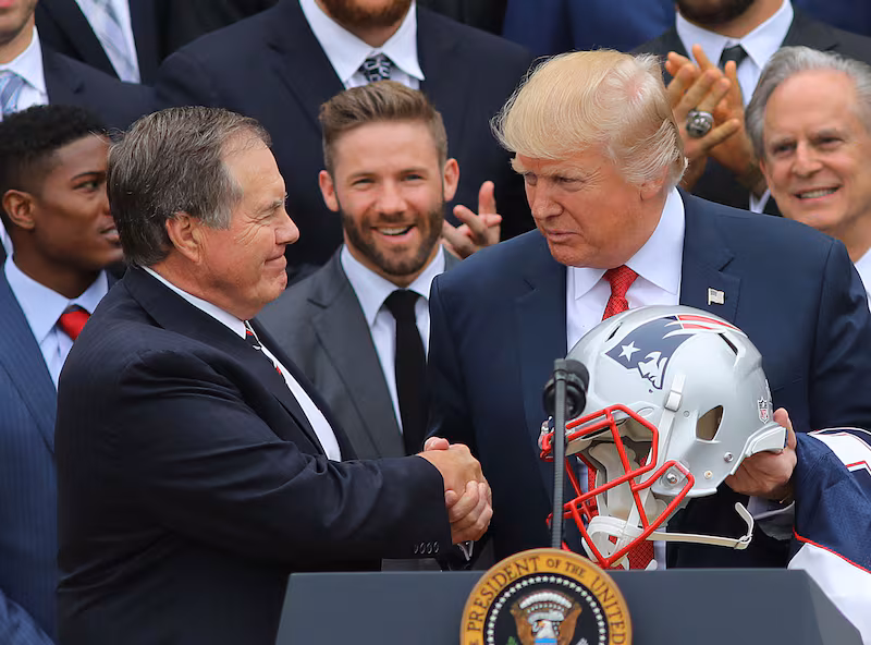 WASHINGTON D.C. - APRIL 19: President Donald Trump shakes hands with New England Patriots head coach Bill Belichick, left, as Patriots player Julian Edelman looks on at center during a ceremony at the White House in Washington D.C. on Apr. 19, 2017. (Photo by John Tlumacki/The Boston Globe via Getty Images)