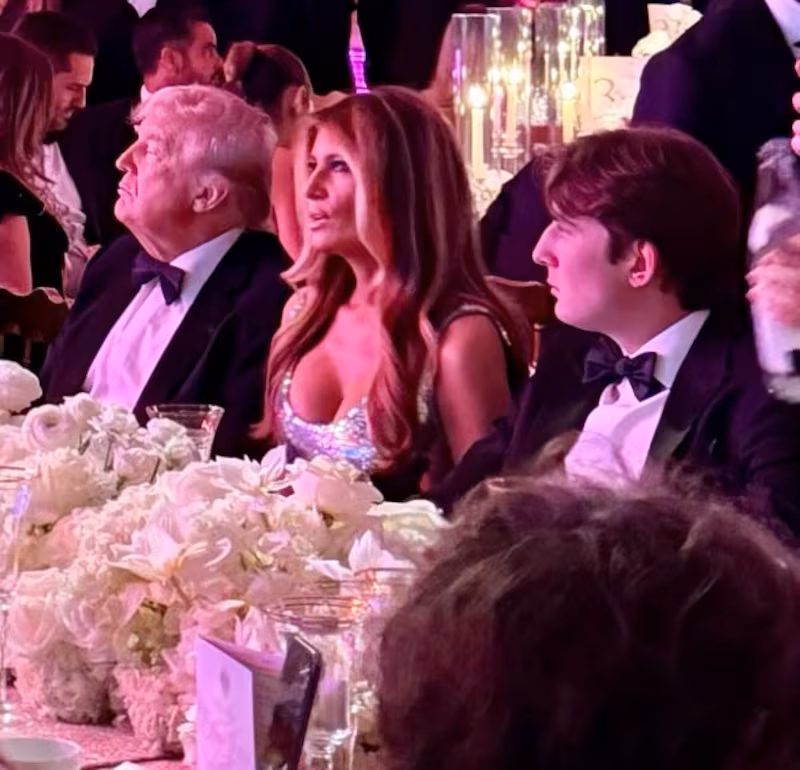Donald and Melania Trump, with their son Barron (R), at the New Year's party at Mar-a-Lago.