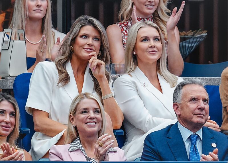 Lindsey Halligan (L) and Karoline Leavitt (C) attend the Men's Singles Final on Day 15 of the 2025 US Open Tennis Championships at the USTA Billie Jean King National Tennis Center on September 07, 2025 in Flushing Meadows, Queens, New York City.
