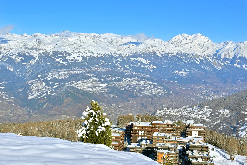 The ski resort of Thyon 2000 in the Southern Swiss Alps with the famous resort of Crans-Montana in the background.