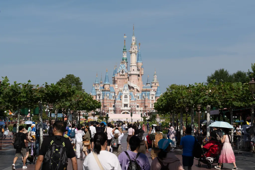 People walk on a path leading to the castle at Shanghai Disneyland.