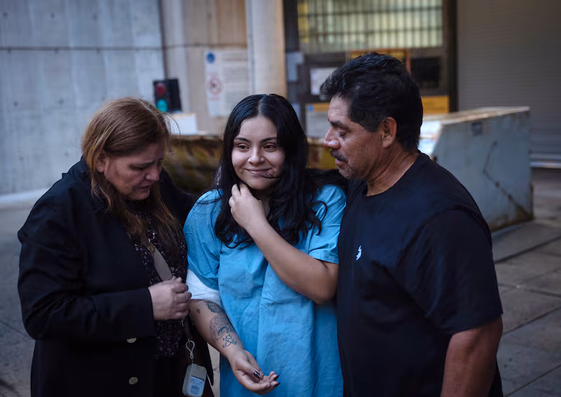Marimar Martinez, center, is greeted by her family after being released from the Metropolitan Correctional Center after being shot by immigration agents