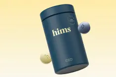 A bottle with the word Hims on it, surrounded by pills.