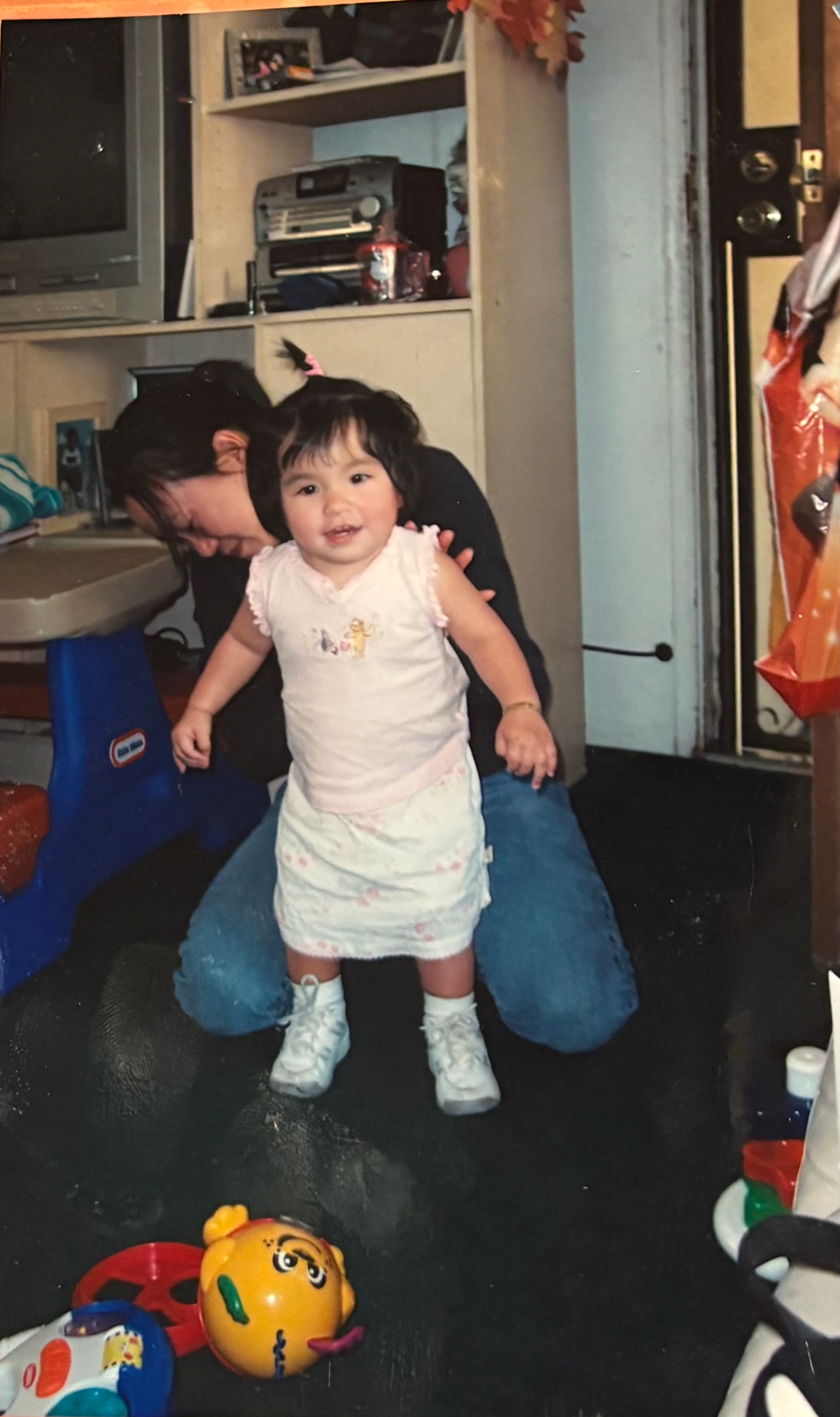 Mejicanos receives at-home physical therapy in 2004 with her physical therapist propping her up.