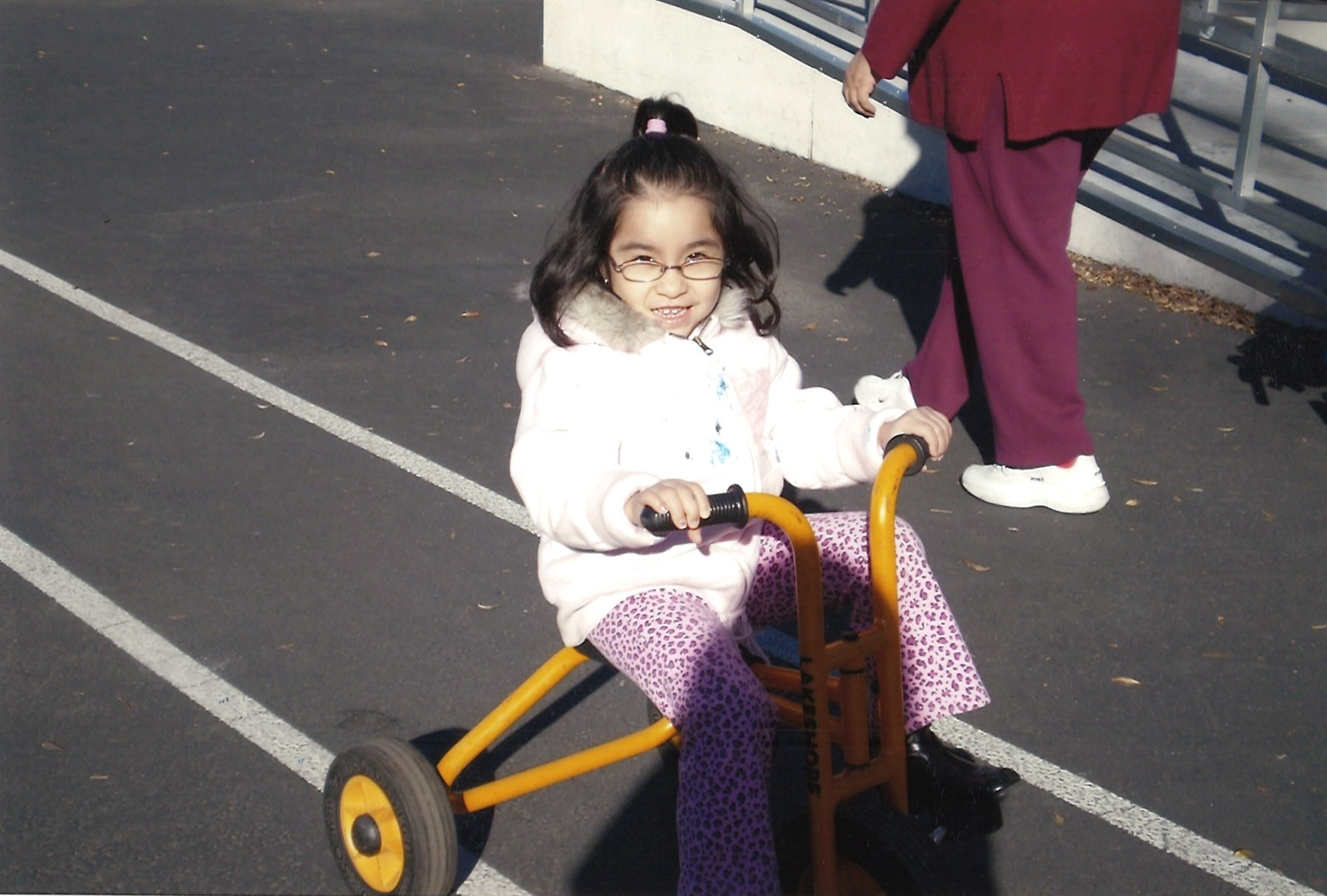 Victoria Mejicanos in 2007 practicing riding a tricycle, which was part of her IEP goals.