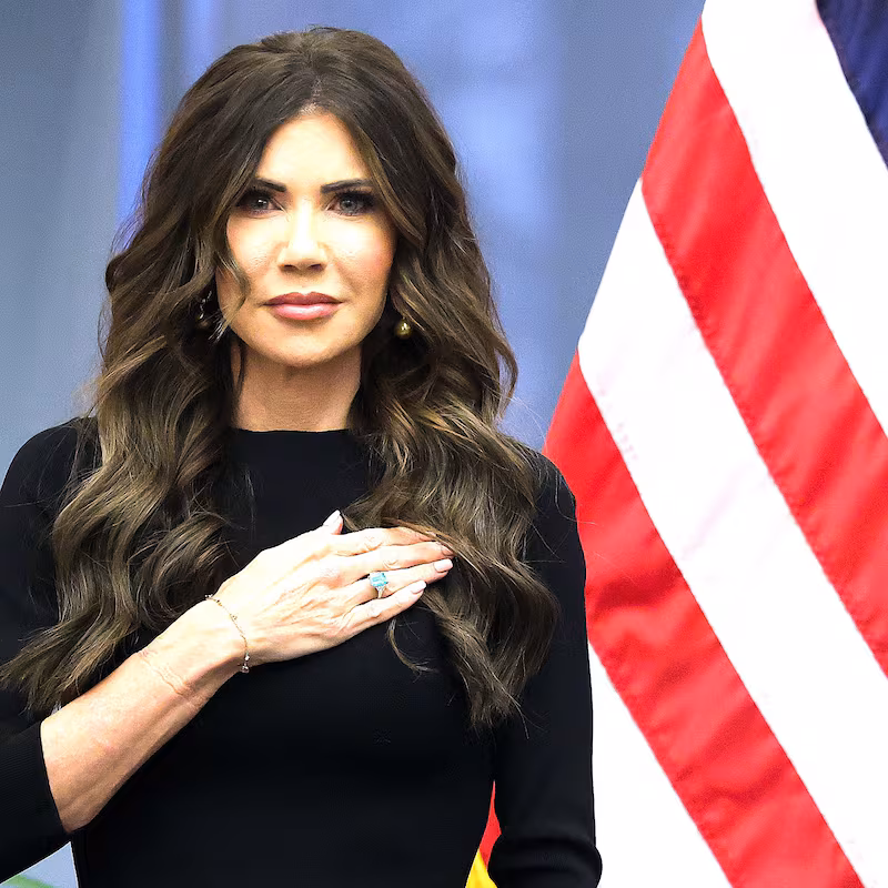Secretary of Homeland Security Kristi Noem stands with Coast Guard Commandant Adm. Kevin E. Lunday