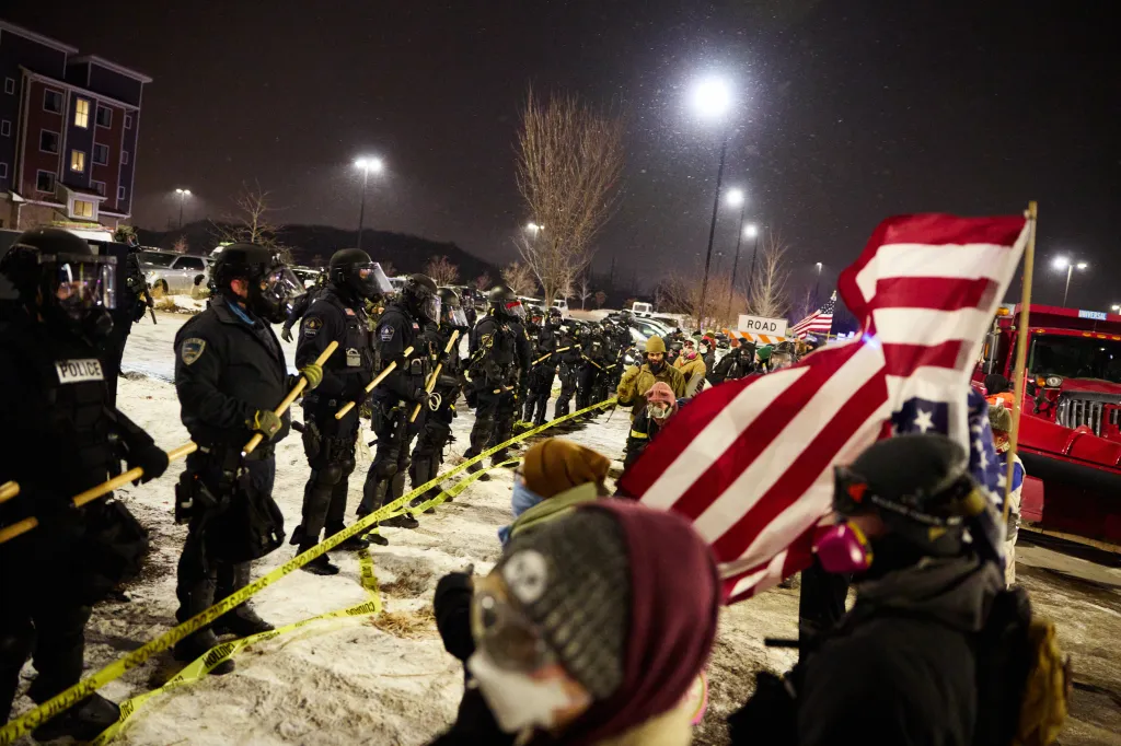 Protesters confront law enforcement officers outside a hotel believed to be housing Gregory Bovino, who has been relieved of his position as US Border Patrol commander at large and is expected to return to El Centro, during a Goodbye Bovino Noise Demo on Monday, Jan. 26, 2026, in Maple Grove, Minnesota