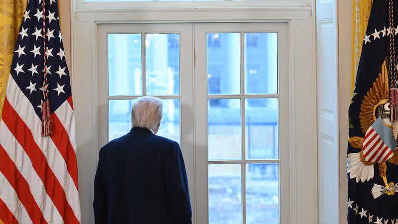 US President Donald Trump looks through a window to observe construction work on his new ballroom prior to a meeting with US oil company executives in the East Room of the White House in Washington, DC, on January 9, 2026. President Trump is aiming to convince oil executives to support his plans in Venezuela, a country whose energy resources he says he expects to control for years to come. US forces seized Venezuelan president Nicolas Maduro in a sweeping military operation on January 3, with Trump making no secret that control of Venezuela's oil was at the heart of his actions. (Photo by SAUL LOEB / AFP via Getty Images)