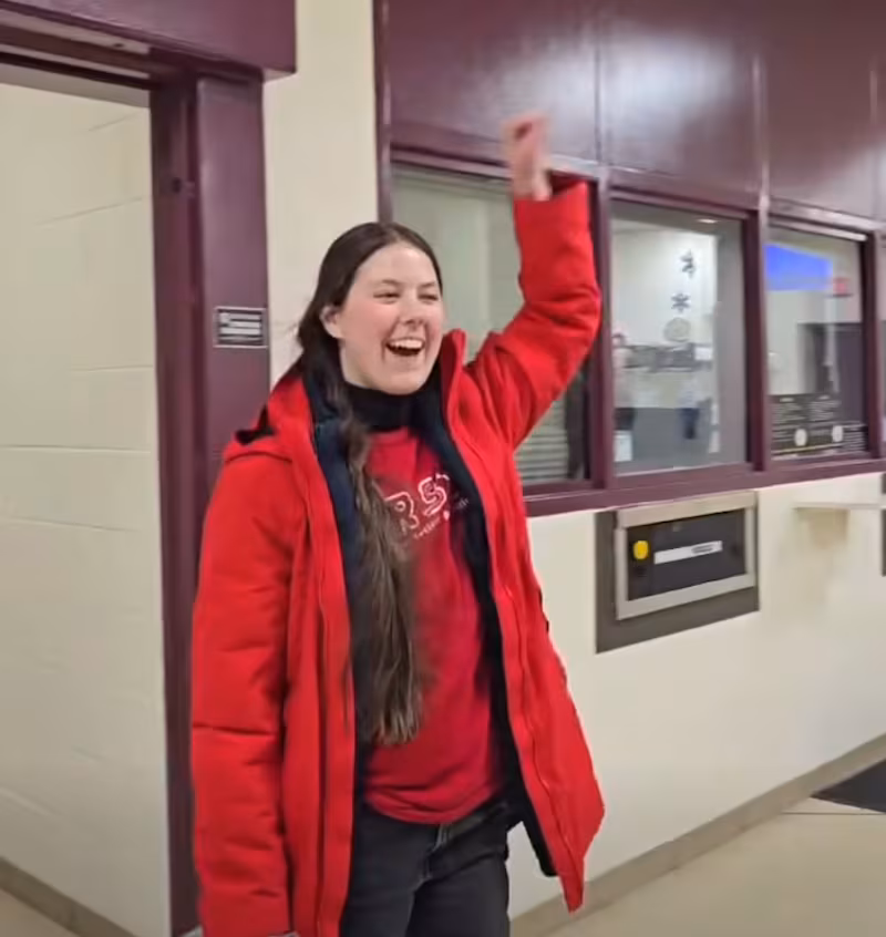 Jessica Plichta punches the air when greeted by her fellow protesters after police released her.
