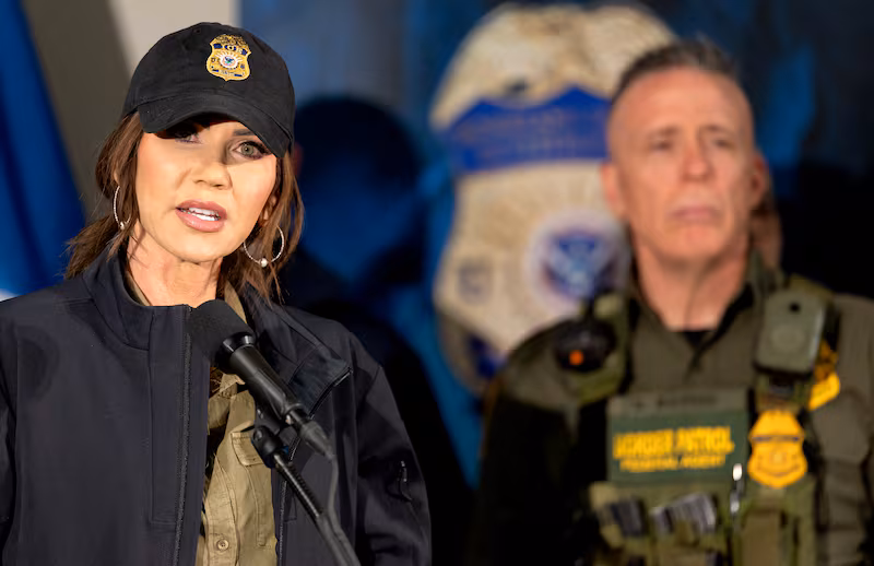 Secretary of Homeland Security Kristi Noem during a press conference at the Bishop Henry Whipple Federal Building in Minneapolis, Minn., on Wednesday, January 7, 2026. Behind Noem is Border Patrol official, Gregory Bovino.