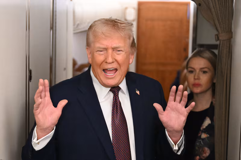 US President Donald Trump speaks to the press aboard Air Force One on January 11, 2026.