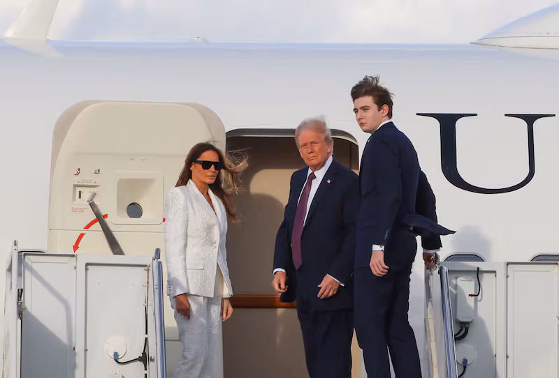 US President-elect Donald Trump, his wife Melania Trump and their son Barron board a US government aircraft at Palm Beach International Airport in West Palm Beach, Florida, on January 18, 2025.
