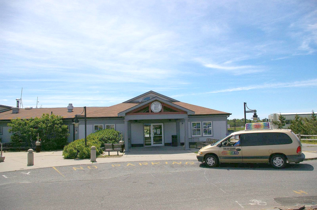P-Town Airport building with a minivan parked in front.