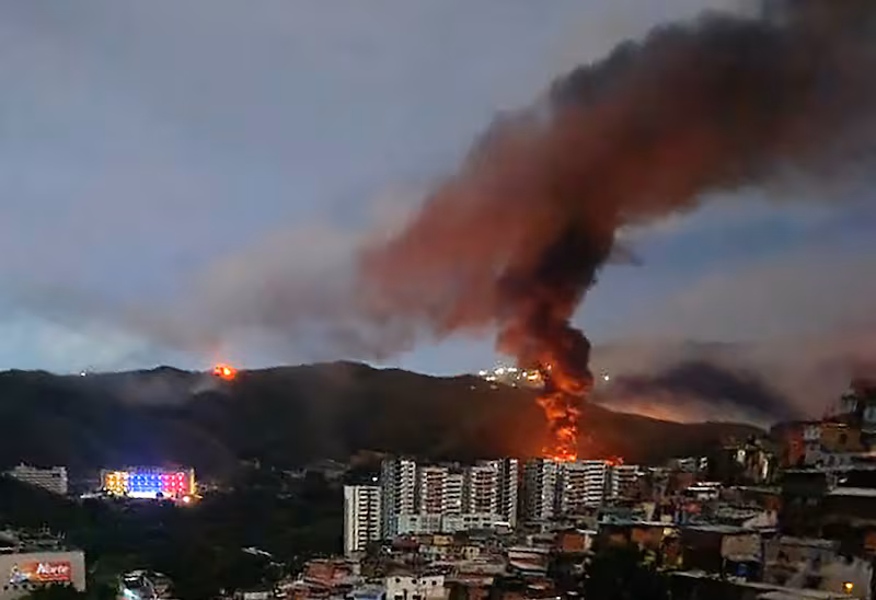 Fire at Fuerte Tiuna, Venezuela's largest military complex, is seen from a distance