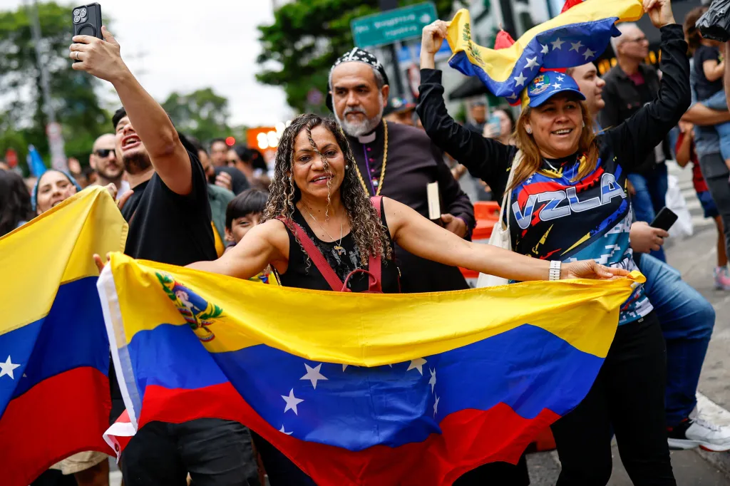 Venezuelans and their supporters celebrate as they take part in a demonstration for freedom and a democratic transition