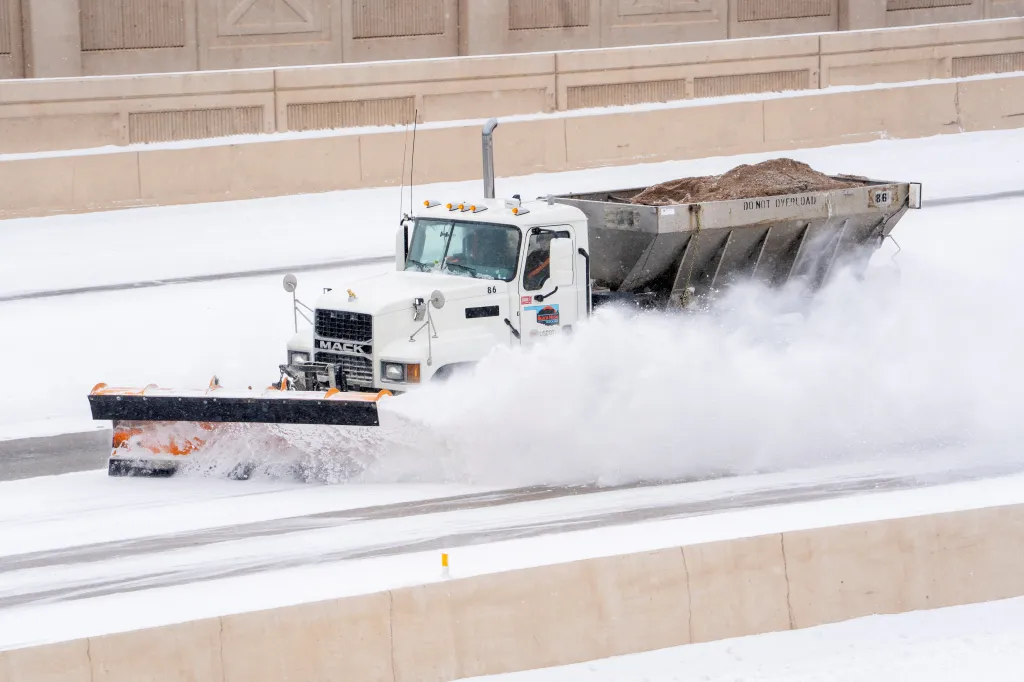 A Mack snowplow clearing snow from a highway in Oklahoma City during Winter Storm Fern.