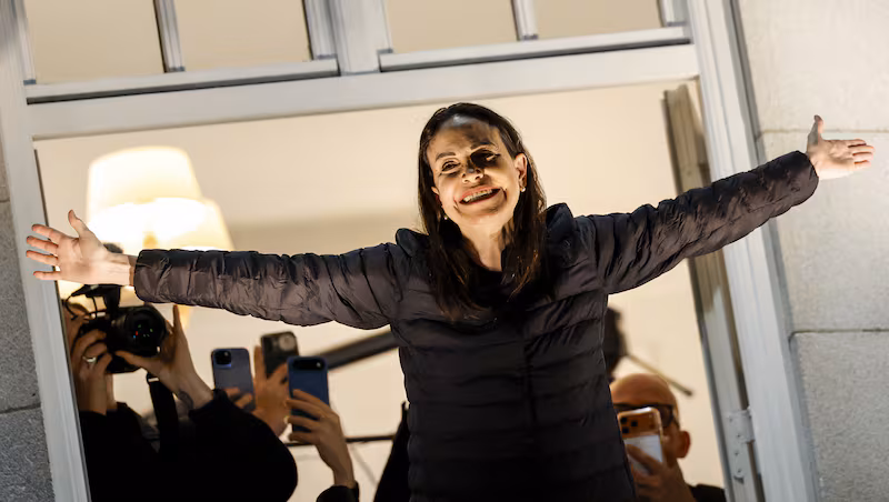 2025 Nobel Peace Prize winner Maria Corina Machado greets supporters from the balcony of the Grand Hotel in Oslo, Norway on December 11, 2025. Machado arrived in Oslo hours after the Venezuelan opposition leader's award was collected on her behalf by her daughter.