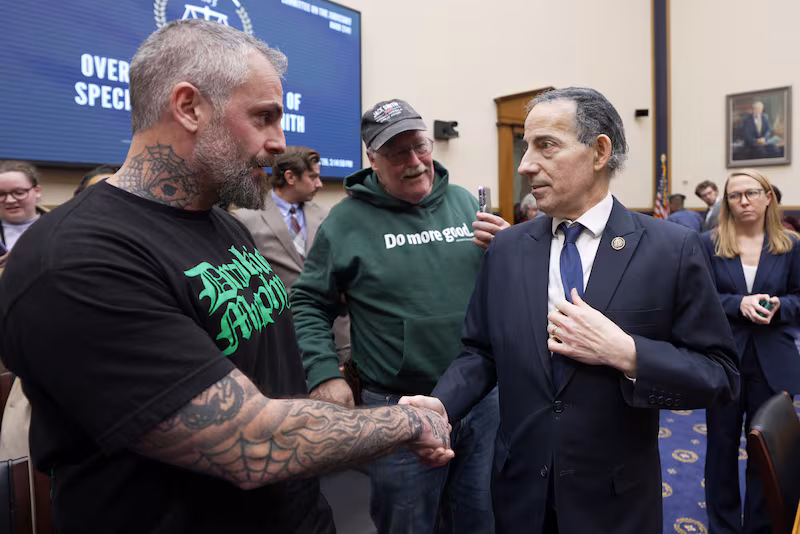 Former Metropolitan Police Department officer Michael Fanone shakes hands with Democratic Rep. Jamie Raskin at the conclusion of testimony from former Special Counsel Jack Smith at a hearing before the House Judiciary Committee on January 22, 2026.