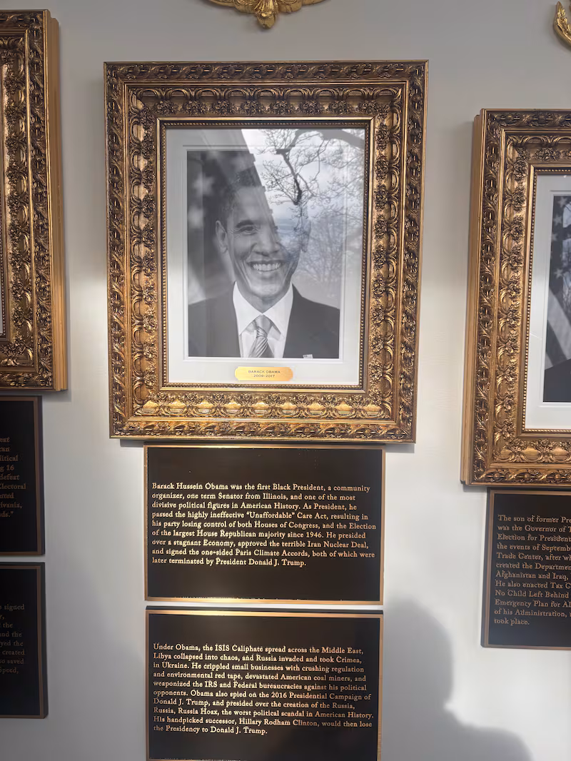 The new signage under the image of President Obama on Donald Trump's