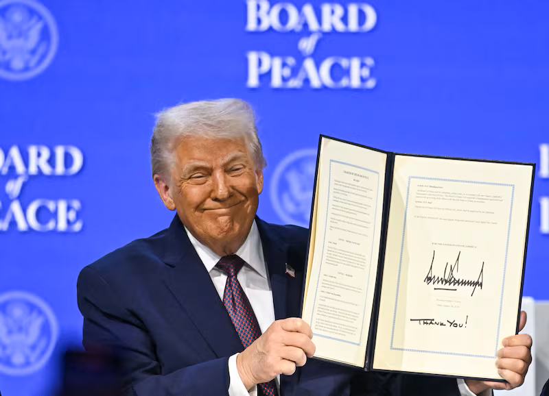 TOPSHOT - US President Donald Trump holds a signed founding charter at the