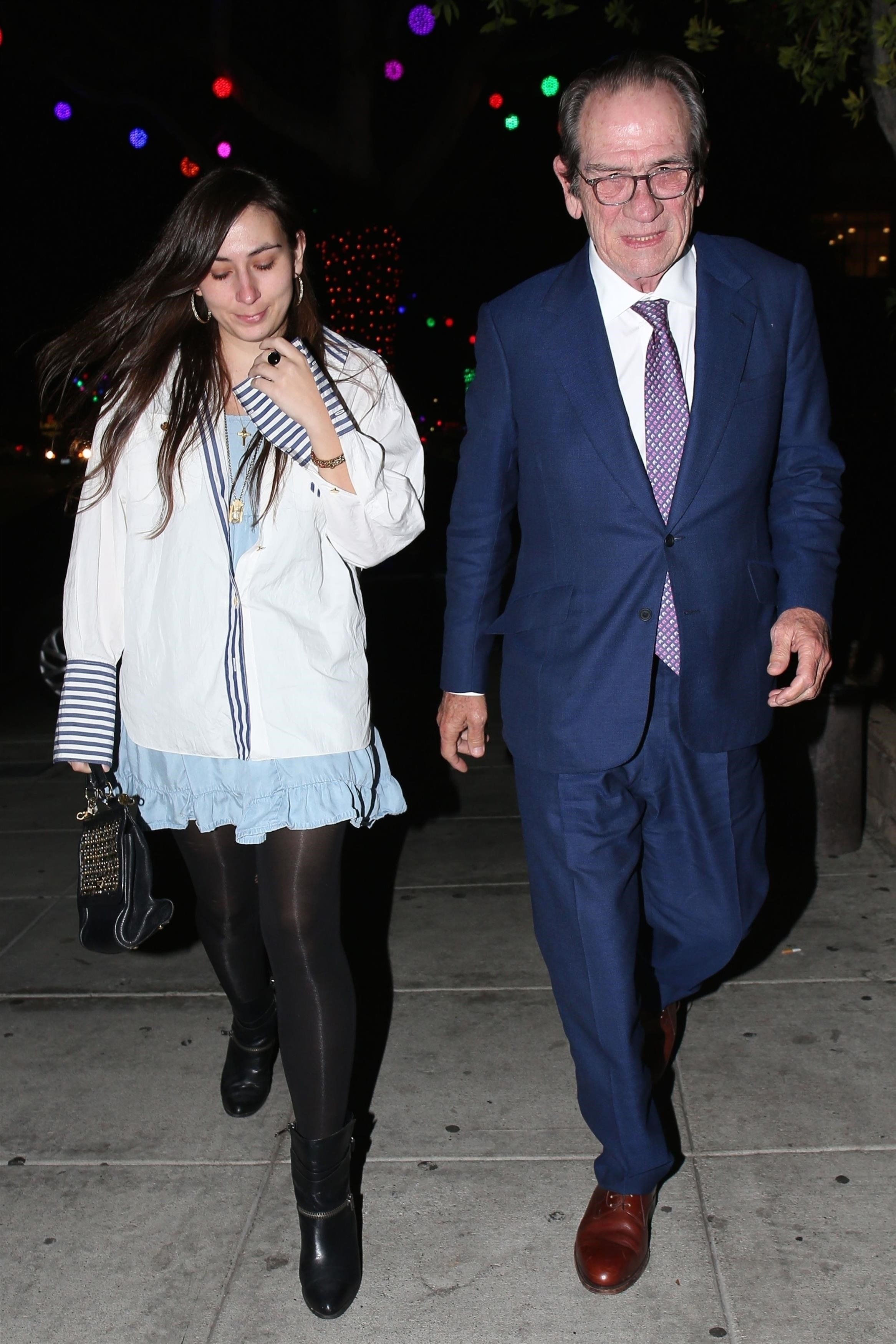 Tommy Lee Jones and daughter Victoria Jones walking together, with Victoria looking down.