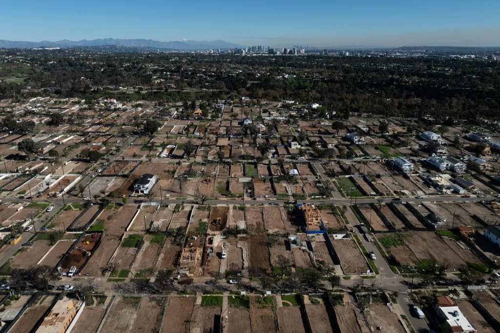 Aerial view of cleared lots and houses being rebuilt in Pacific Palisades, Los Angeles, months after the Palisades Fire.