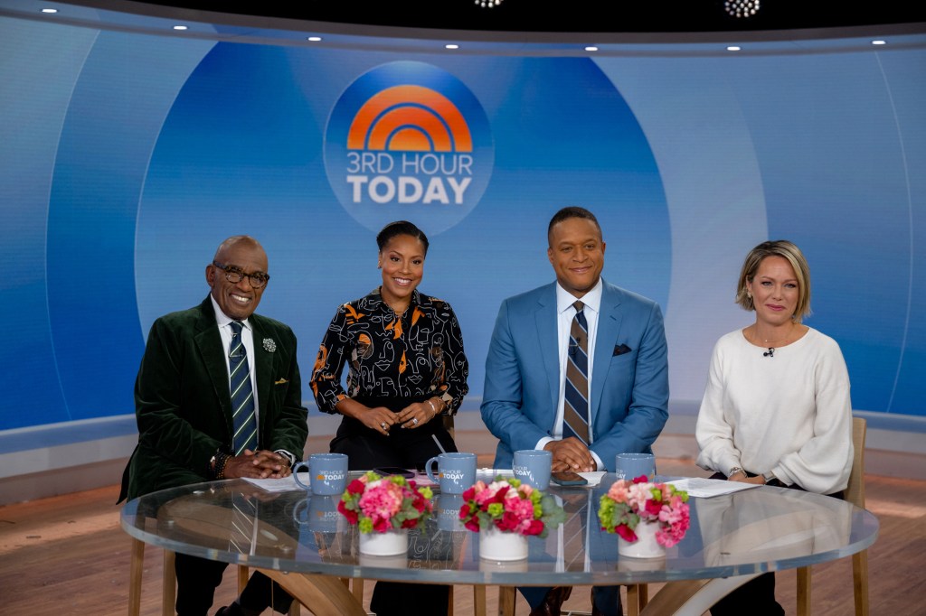 Al Roker, in a black blazer and striped tie, Sheinelle Jones, in a black pattered dress, Craig Melvin,in a blue suit and striped tie, and Dylan Dreyer, in a white dress, sitting at a table with 