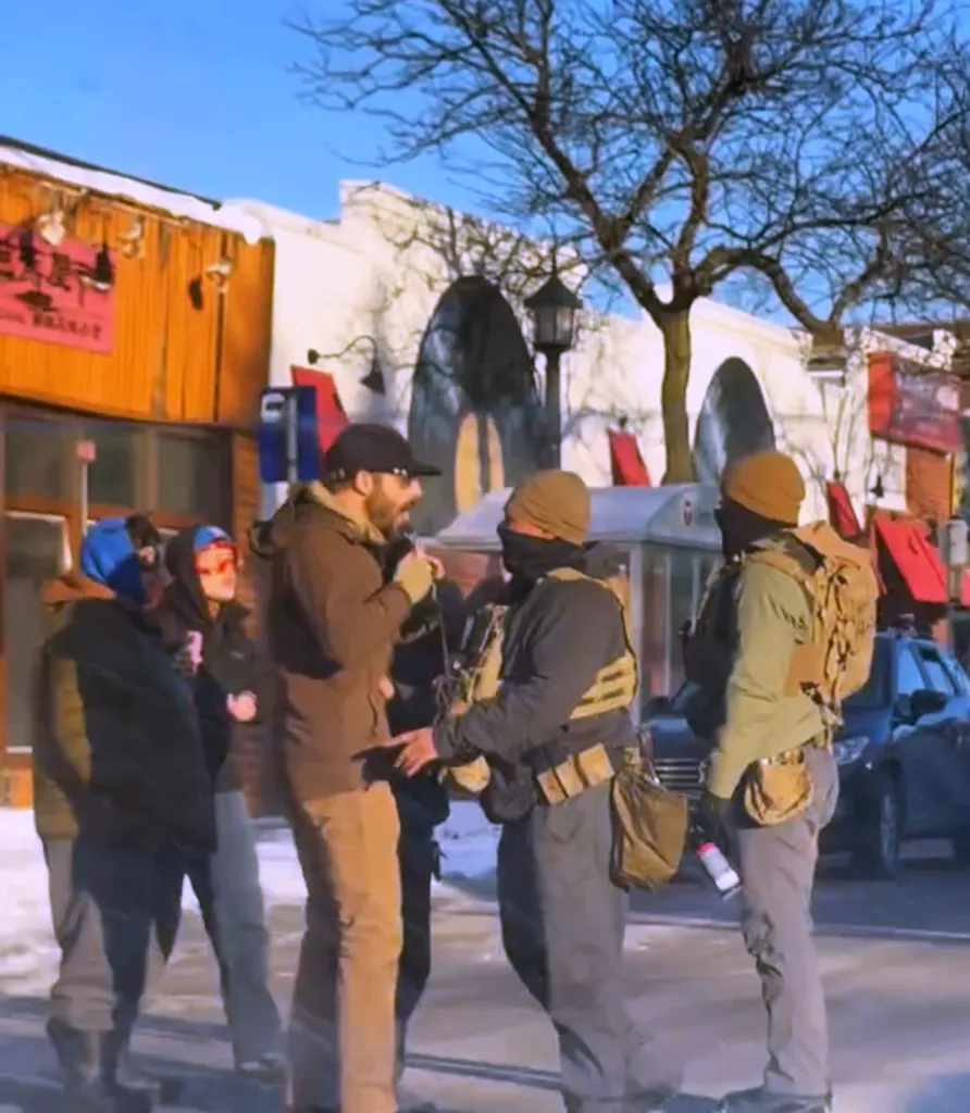 A group of federal agents confronting a protester.
