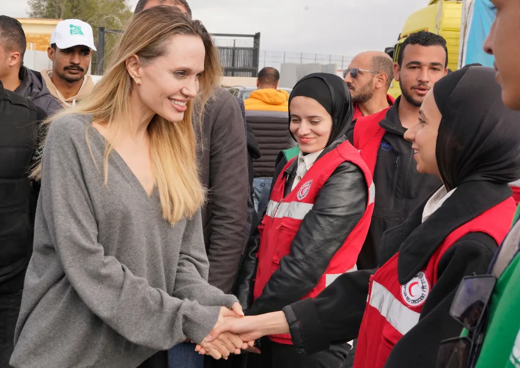 Angelina Jolie greets Red Crescent workers at the Rafah border crossing.