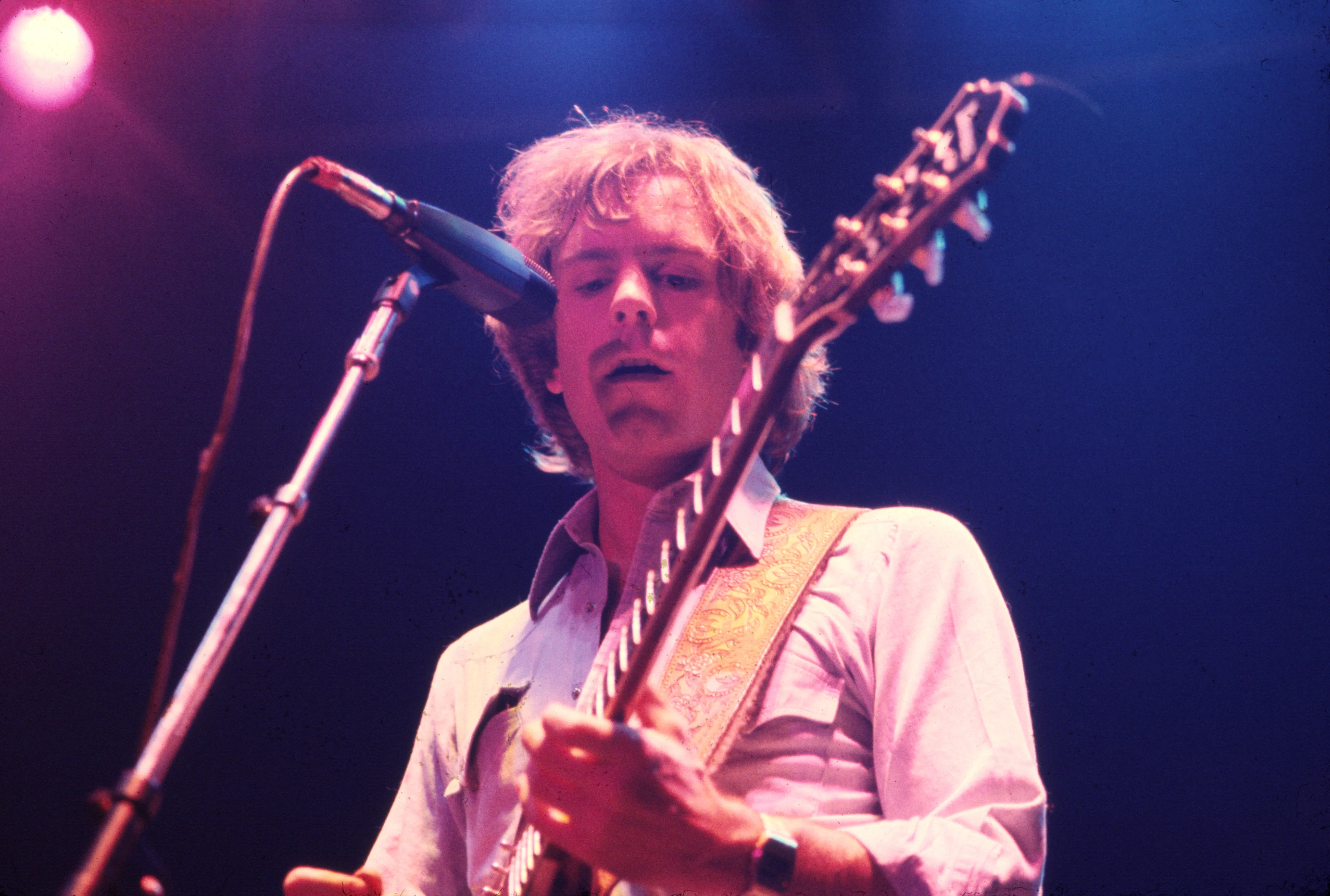 Bob Weir playing an electric guitar onstage.