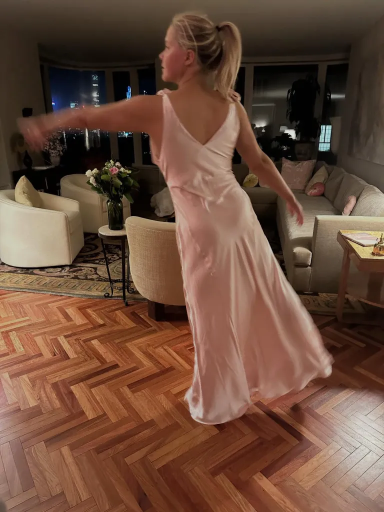 Amy Schumer modeling a light pink slip dress.